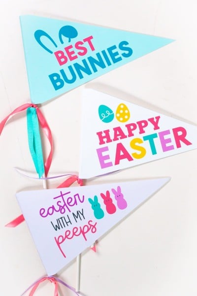 Three of the printable easter pennants on a white table.