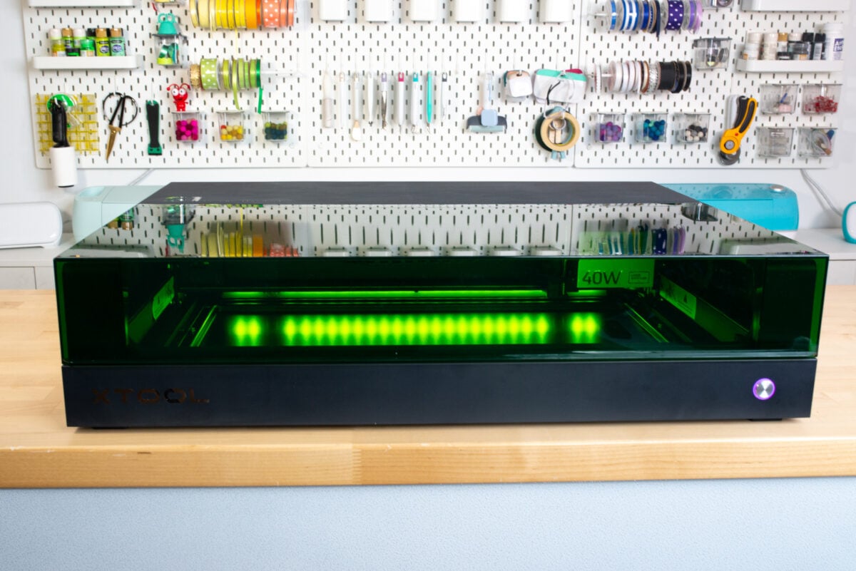 xTool S1 sitting on a table with glowing green lights